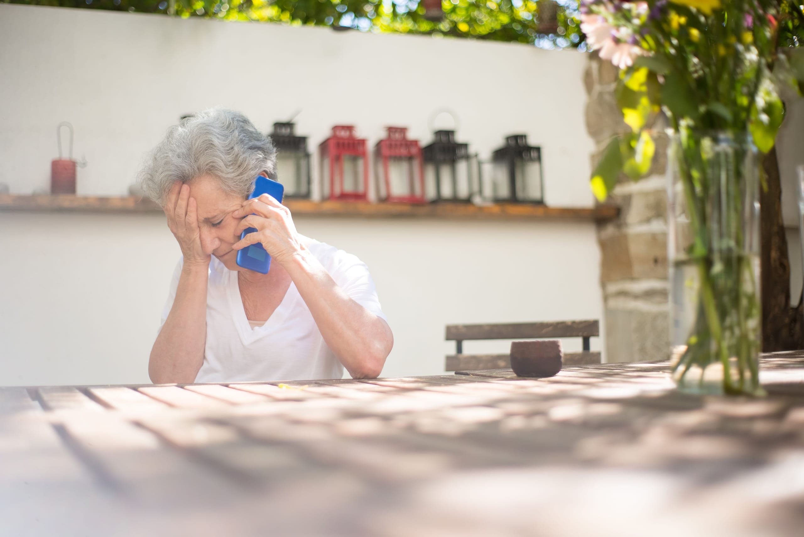 Senior looking concerned while on the phone
